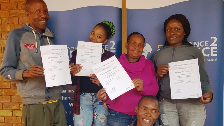 Community participants showcasing their certificates of attendance